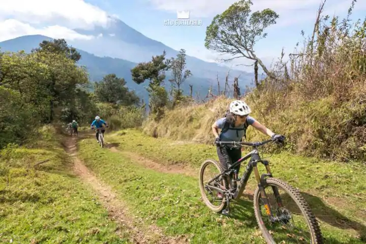 Hiking a bike on the traverse to Tecpán - Volcán Acatenango (3976m) behind.  Valle Escondido Adventure MTB Tour  Chimaltenango, Guatemala