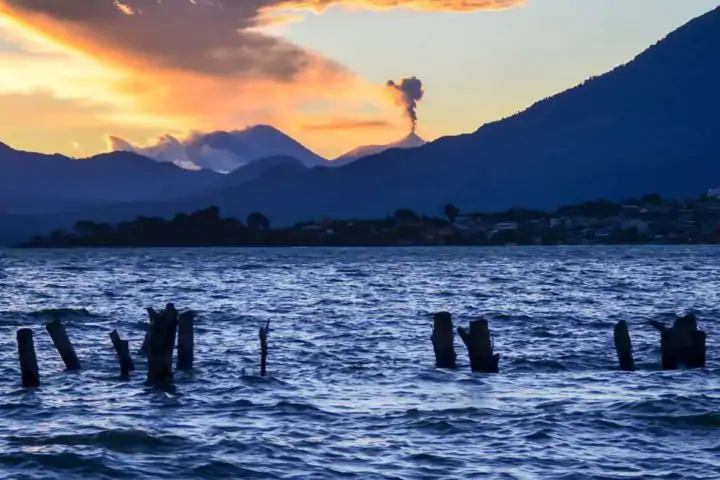 Errupting fuego volcano as seen from Lake Atitlán Lake Atitlán , Guatemala